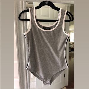 Grey body suit with black and white side strips